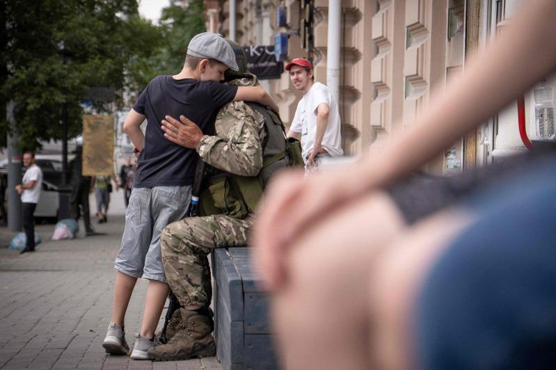 一名俄國男孩擁抱瓦格納士兵。(Getty Images)