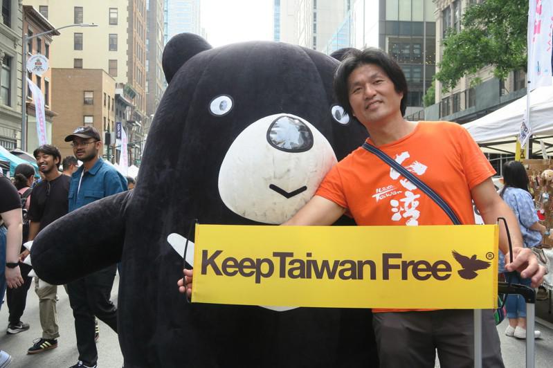 紐約台灣市集總策畫許伯丞17日在台灣黑熊吉祥物前舉Keep Taiwan Fre...